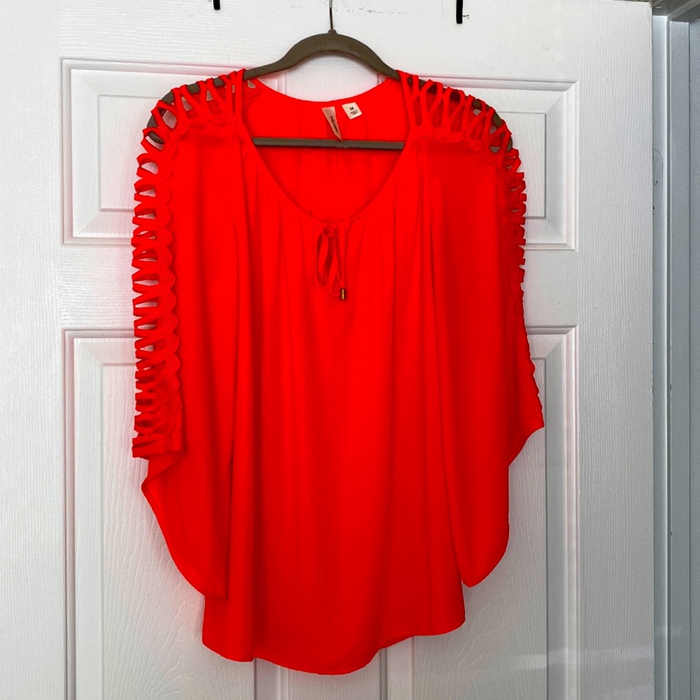Wide 3/4 sleeve blouse with tie neck. Neon pink with open sleeve detail.